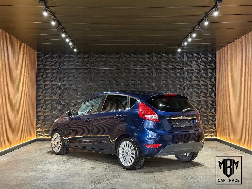 ✅Ford Fiesta 1.2i Titanium GARANTIE Airco Parksensoren 1.Eig, Voorwielaandrijving, Euro 5, Stof, 4 cilinders