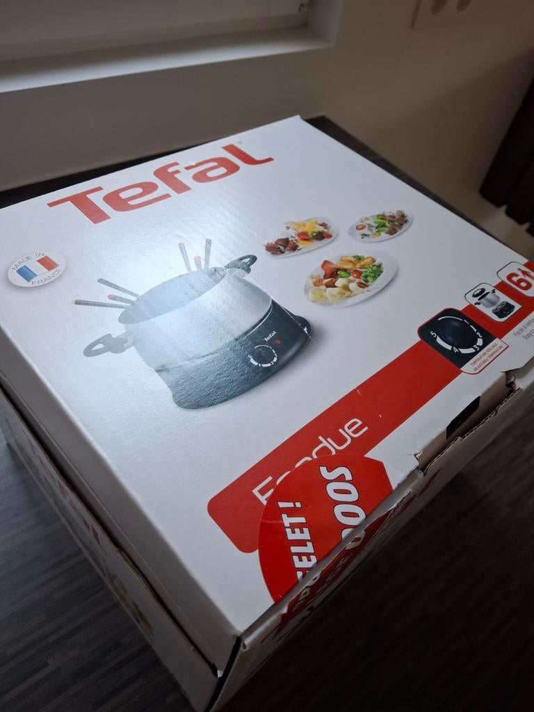 Gloednieuwe fondueset., Ophalen