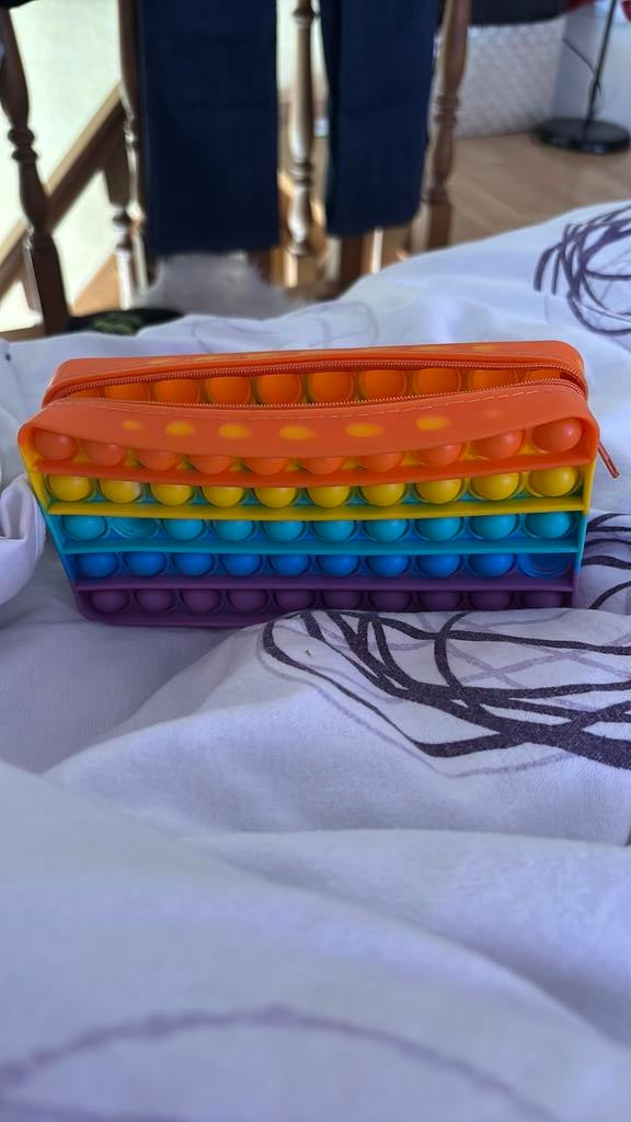 Pop-it pennenzak, Ophalen