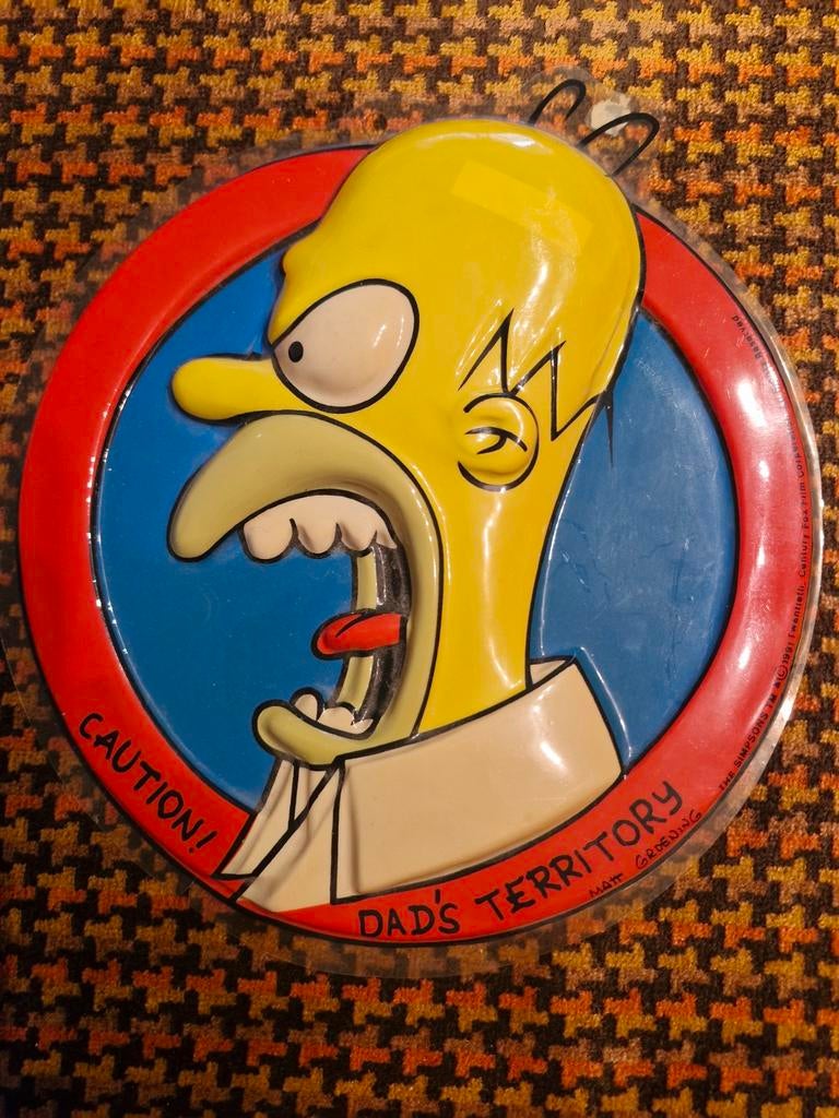 Homer Simpson plastic plaat, Ophalen