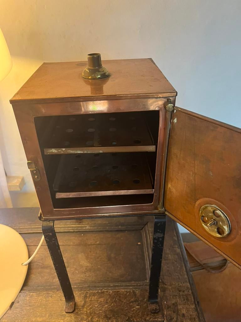 Een antieke koperen medische sterilisator, Ophalen