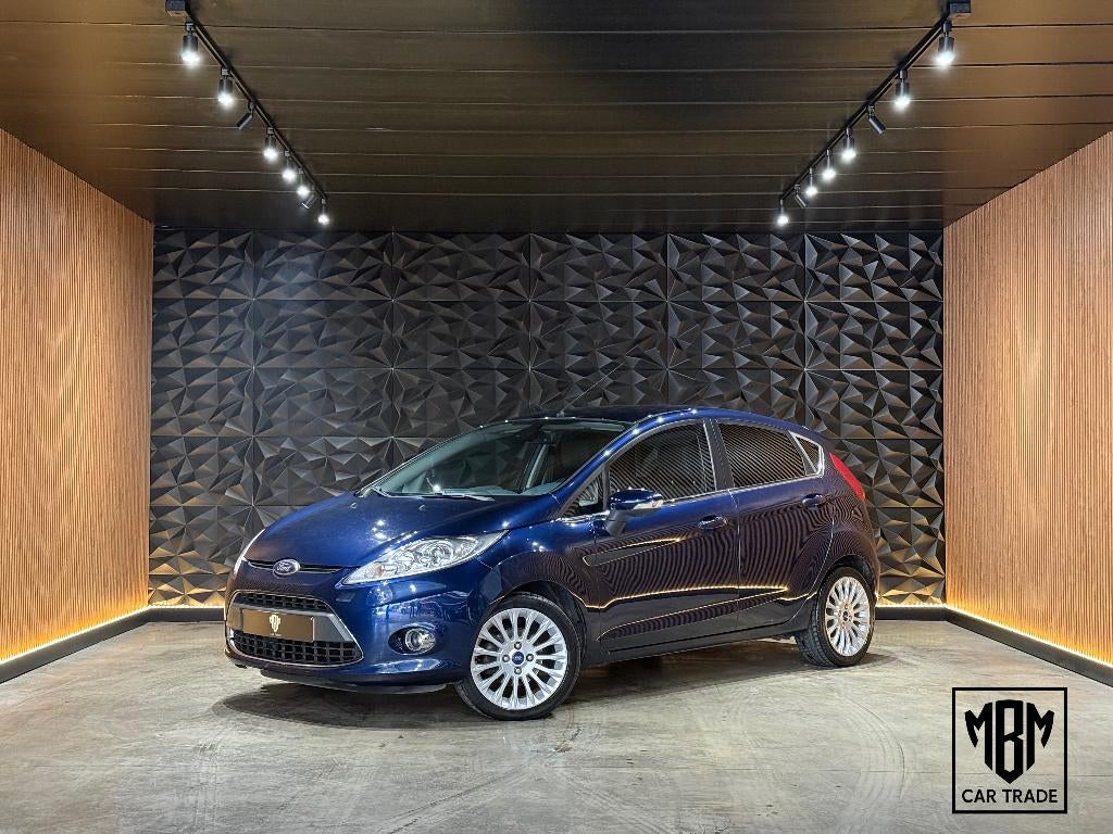 ✅Ford Fiesta 1.2i Titanium GARANTIE Airco Parksensoren 1.Eig, Voorwielaandrijving, Euro 5, Stof, 4 cilinders