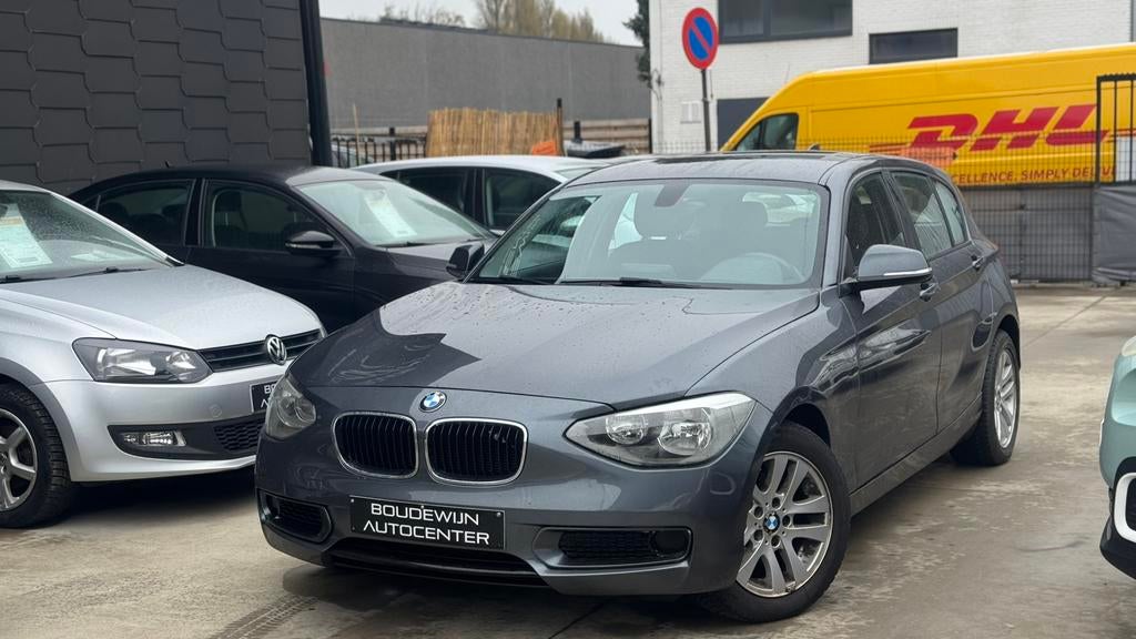 Bmw 1 Serie 116i Automaat 1.6Benzine Topstaat 142.xxxkm, Zwart, 5 deurs, https://public.car-pass.be/vhr/a2b14aae-e446-422d-b46d-812df094fc6f
