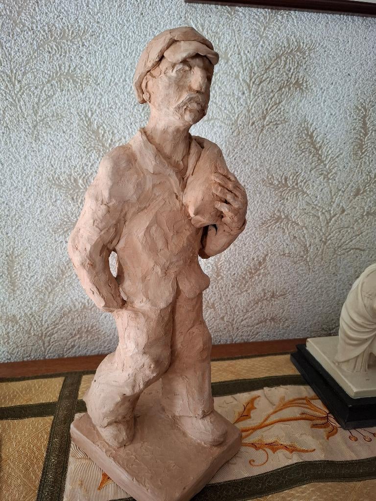 Beeld in klei - werkman, Ophalen